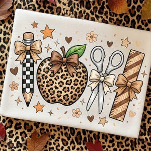 May include: A white fabric surface featuring a graphic illustration of a pencil with a black and white checkered pattern, a leopard print apple, silver scissors, and a wooden ruler, each adorned with a tan bow, surrounded by stars, hearts, and flowers.