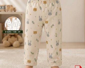 May include: Cream-colored pajama pants with a repeating pattern of gray bunnies, brown bears, and green sprigs. The pants have an elastic waistband and are worn by a child. Text on the image reads "6 SIZES | 12M - 5Y".