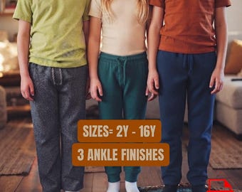 May include: Three pairs of pants worn by children. The left pair is charcoal gray, the center pair is dark green with a drawstring waist, and the right pair is navy blue. Text on the image reads: SIZES= 2Y - 16Y and 3 ANKLE FINISHES.