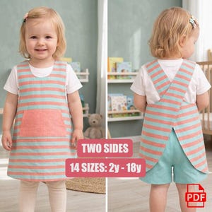 May include: A reversible pinafore dress featuring horizontal coral and light blue stripes with a front pocket. The back view shows a cross-back design worn over shorts. The text on the image reads TWO SIDES and 14 SIZES: 2y - 18y, with a PDF icon.