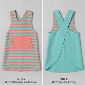 May include: A reversible apron featuring two distinct sides. Side A displays horizontal coral and teal stripes with a central coral pocket. Side B shows a solid teal color with a cross-back design. The text labels SIDE A and SIDE B are visible.