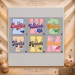 May include: A sheet of six premium DTF transfers featuring varsity-style letters with gingham patterns and mascot graphics. The designs include Eagles, Wildcats, Gators, Tigers, Hornets, and Mustangs, each decorated with star accents and numbered one through six.