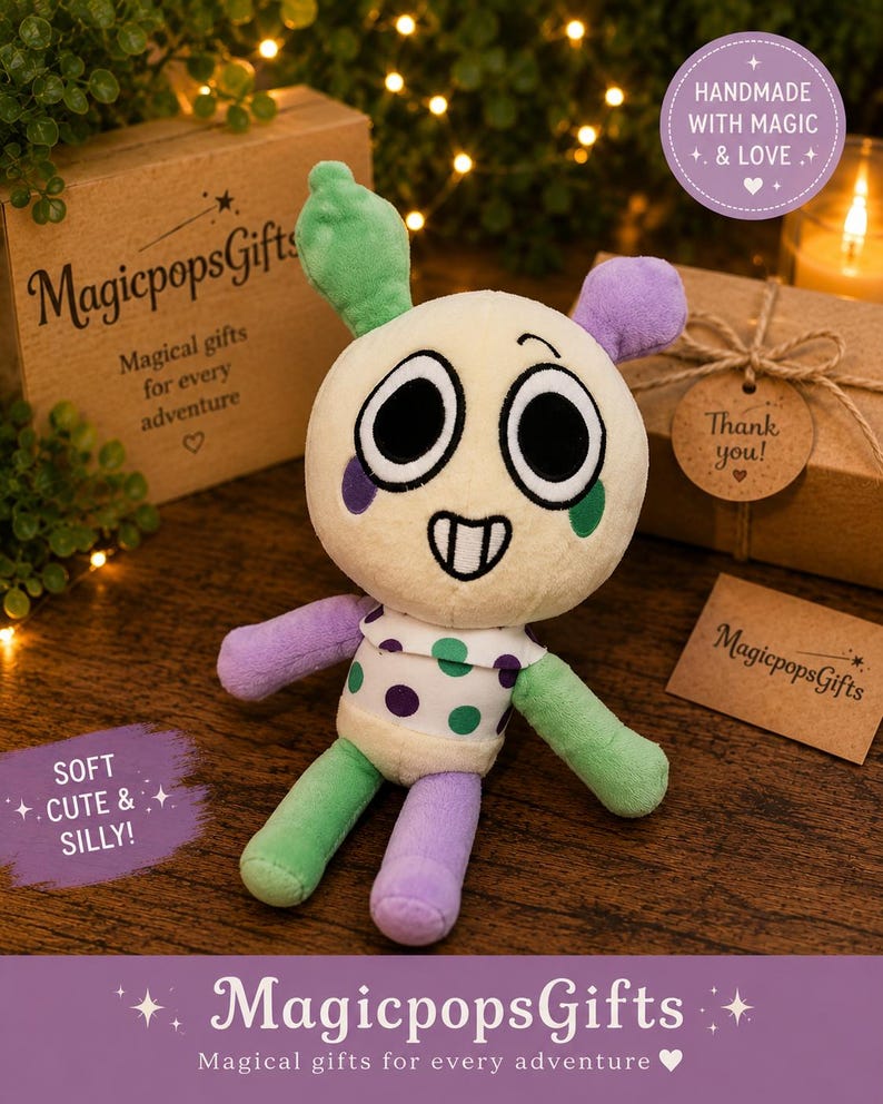 May include: A plush toy with a round cream-colored head, large black eyes, and a stitched smile. It has green and purple ears, arms, and legs, and a white shirt with purple and green polka dots. The text "MagicpopsGifts" is visible.