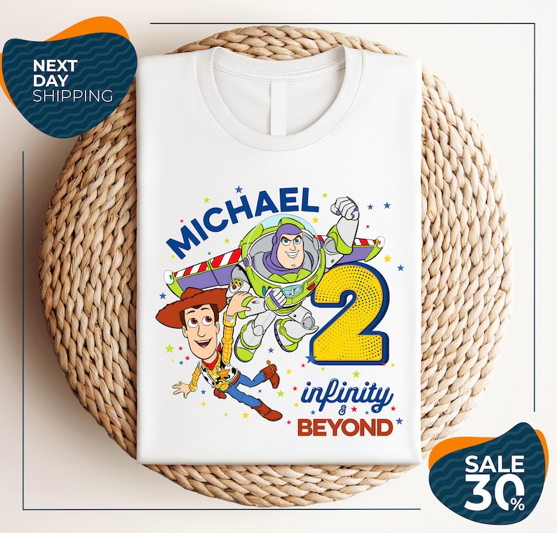 A white t-shirt with a graphic design featuring Buzz Lightyear and Woody from Toy Story, along with the text "Michael 2 Infinity Beyond".