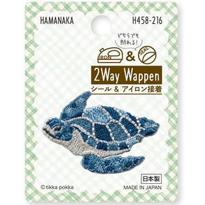 Puede incluir: Un parche de tortuga marina Hamanaka H458-216 2Way Wappen termoadhesivo y autoadhesivo sobre una tarjeta de soporte a cuadros verdes y blancos. El parche bordado presenta un diseño de tortuga marina azul y blanco con costuras detalladas y texto.