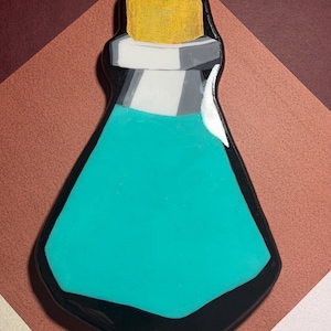 May include: A teal potion bottle with a black outline and a yellow cork. The bottle has a white and gray neck. The background is a geometric pattern of brown and white.