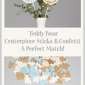 May include: Teddy bear centerpiece sticks and confetti in brown, blue, and white. The sticks feature a brown teddy bear on a blue circle and a blue teddy bear on a brown circle. The confetti is in the shape of teddy bears.
