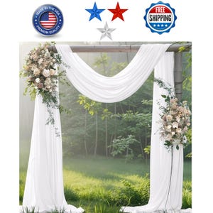 May include: A white wedding arch with draped fabric and floral arrangements. The arch is set outdoors with a natural backdrop. The image includes patriotic stars and a "Made in the USA" seal.