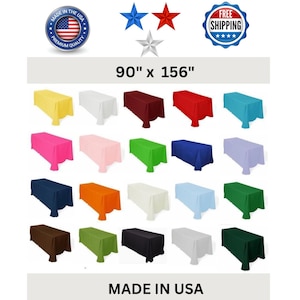 May include: A selection of rectangular tablecloths in various colours, including yellow, white, burgundy, red, and teal. The tablecloths are 228.6 cm x 396.24 cm and are labelled "MADE IN USA".