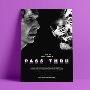 May include: A black and white movie poster with the title "PASS THRU" in a bold, layered font. The poster features a close-up of a man's face and a tiger's face, both looking at each other. The text below the title reads "A film by Neil Breen".