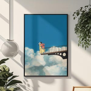 May include: Framed art print featuring a couple on a bridge above the clouds. The artwork has a blue sky background with white clouds. The couple is wearing red and yellow clothing. The print is in a black frame.