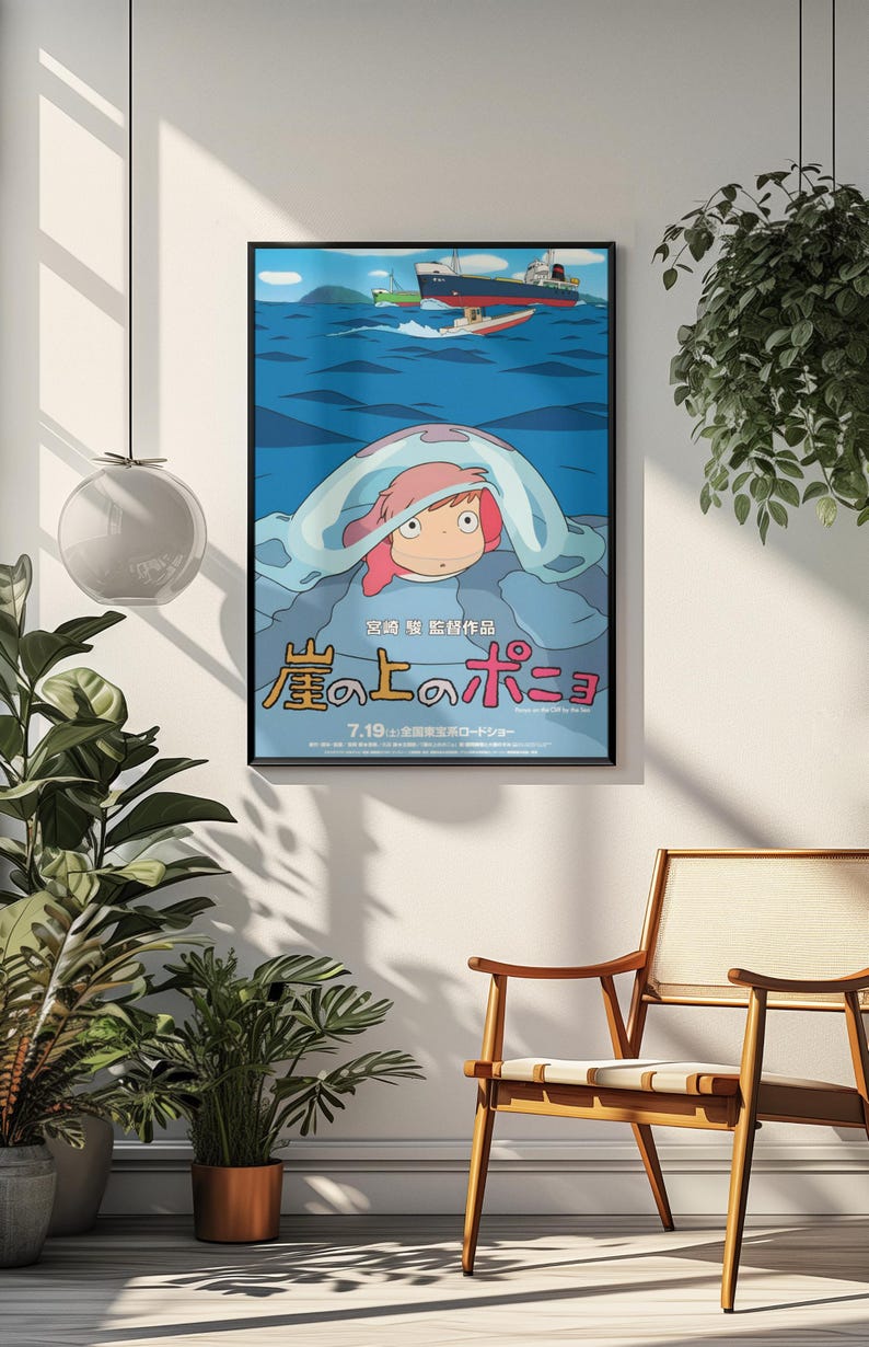 May include: A framed movie poster featuring a cartoon character with pink hair under a blue wave, with ships in the background. Japanese text is visible at the bottom. The poster is displayed on a white wall.