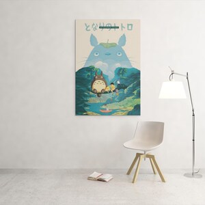 May include: A framed art print featuring a scene from the animated film "My Neighbor Totoro." The artwork depicts Totoro and other characters in a forest setting, with Japanese text at the top. The color palette includes blues, greens, and beige.