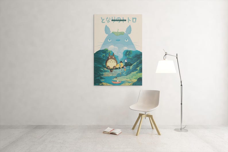 May include: A framed art print featuring a scene from the animated film "My Neighbor Totoro." The artwork depicts Totoro and other characters in a forest setting, with Japanese text at the top. The color palette includes blues, greens, and beige.