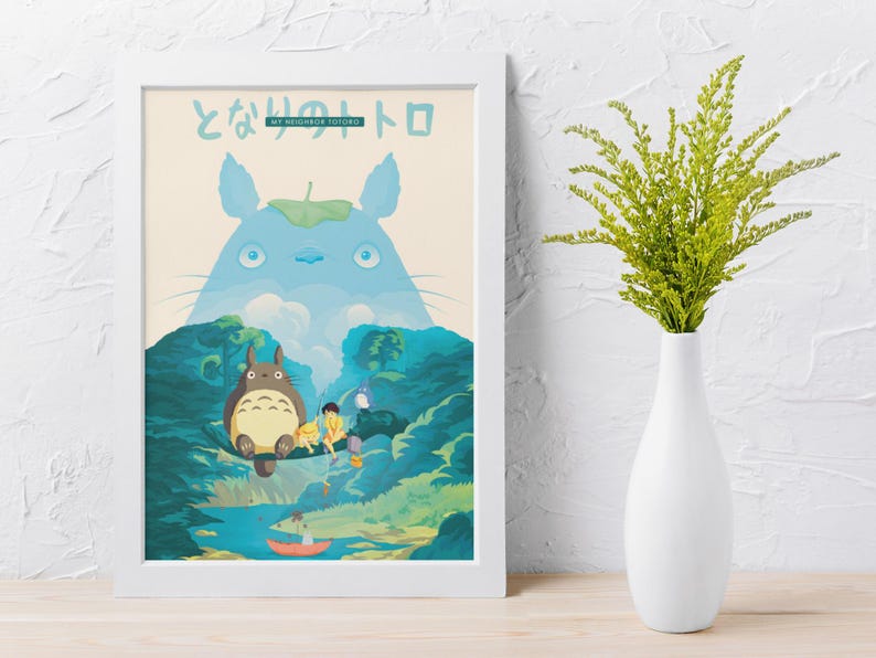 May include: A framed art print featuring characters from the animated film, "My Neighbor Totoro." The artwork depicts Totoro, a large forest spirit, with other characters in a vibrant forest scene. The print is in a white frame.
