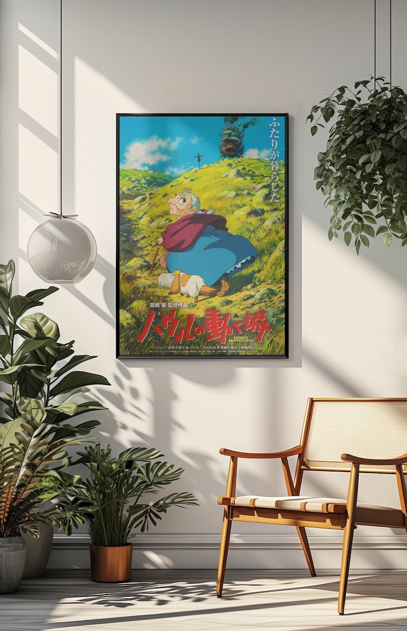 May include: Framed poster featuring a scene from an animated film. The artwork depicts a character in a blue dress and red shawl, with a dog, on a grassy hill. A castle is visible in the background under a blue sky. Japanese text is at the bottom.