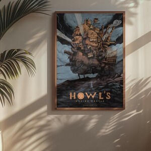 May include: Framed poster featuring a detailed illustration of Howl's Moving Castle, a fantastical structure with intricate details, set against a cloudy sky. The poster has a brown frame and the title "Howl's Moving Castle" is displayed in gold lettering.