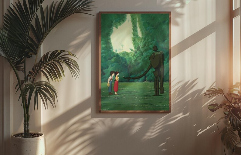 May include: A framed rectangular wall art print featuring an animated scene of two figures standing in a lush green forest clearing facing a tall, slender, dark-colored robotic figure with a long arm extended toward them under a bright sky.