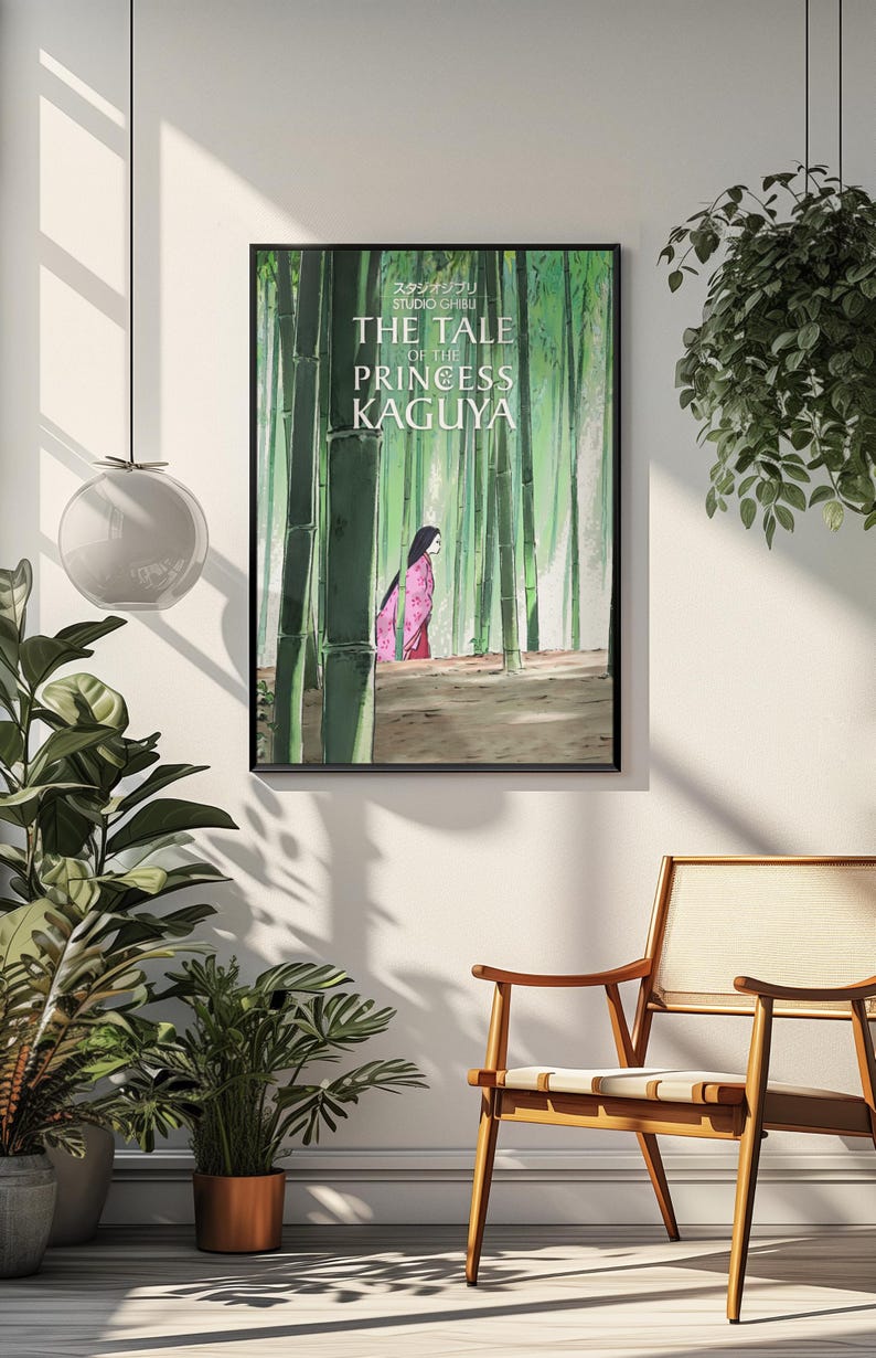 May include: Framed poster featuring an illustration from "The Tale of the Princess Kaguya." The artwork depicts a woman in a pink kimono walking through a bamboo forest. The poster is in a black frame.