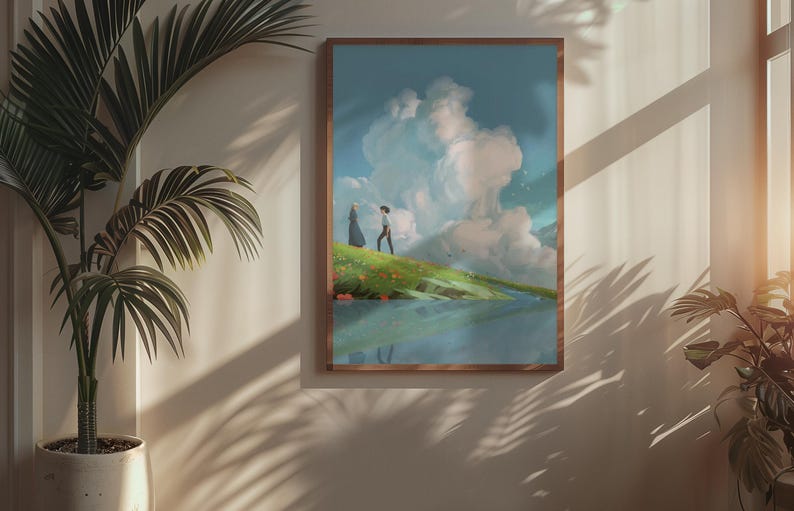 May include: A framed art print depicts a serene landscape with two figures on a grassy hill, overlooking a body of water. The sky is filled with fluffy white clouds. The artwork is in a wooden frame, displayed on a neutral-colored wall.