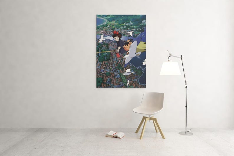 May include: A framed art print featuring an anime-style illustration of a girl with red hair flying over a town with seagulls. The artwork has a vibrant color palette and a detailed cityscape.