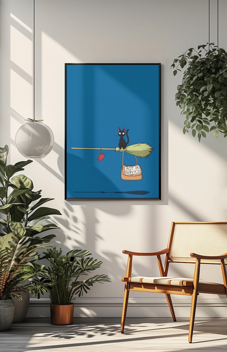May include: A framed illustration features a black cat riding a broom against a blue background. The broom has a sign that reads "NOT IN SERVICE" and a red tag. The artwork is displayed in a room with plants and a wooden chair.