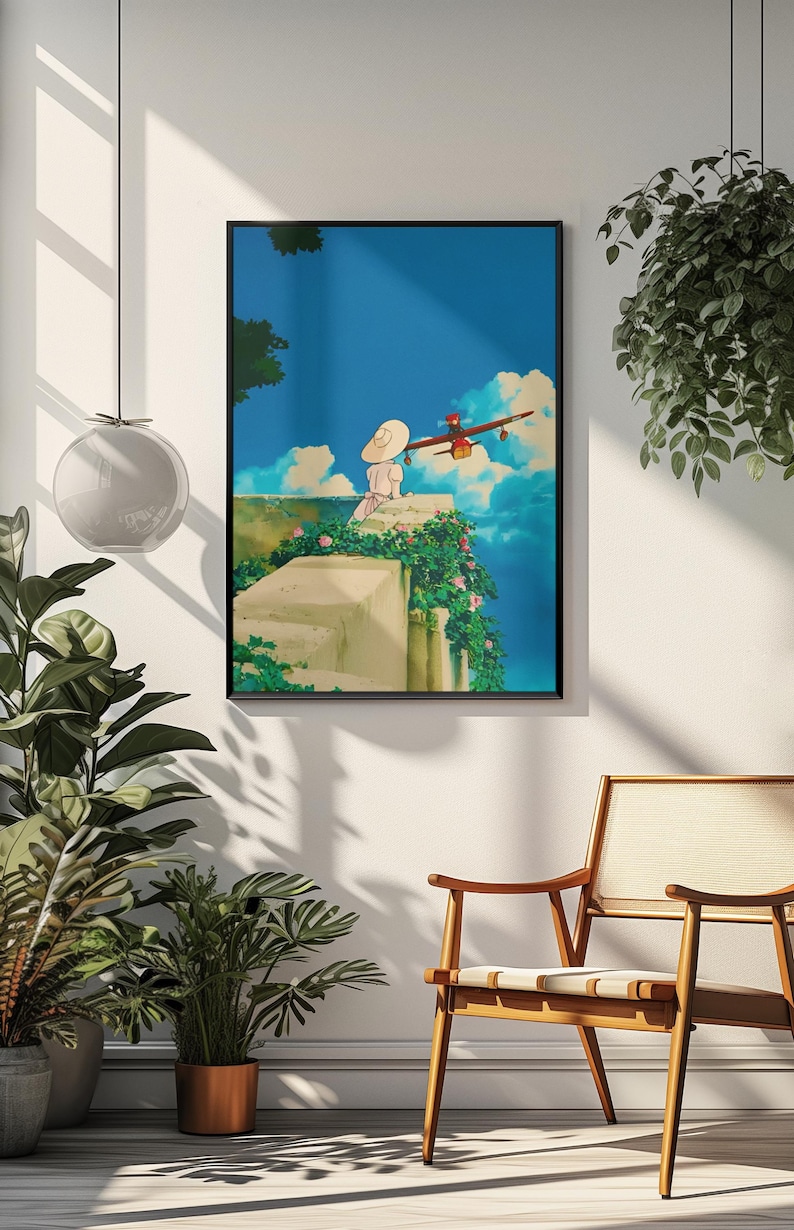 May include: Framed art print featuring an anime scene. A person in a white dress and hat sits on a stone wall, looking at a red and brown airplane flying in a blue sky with clouds. The artwork is framed in black.