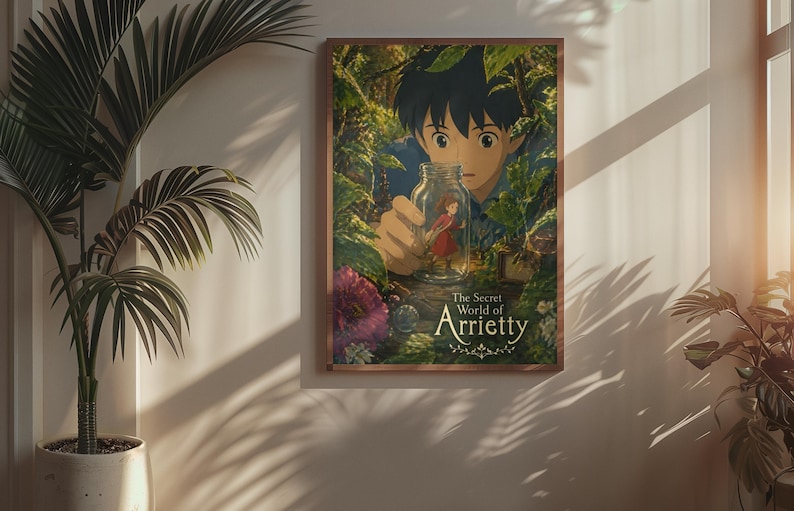 May include: A framed poster of the animated film "The Secret World of Arrietty." The artwork depicts a young boy peering at a tiny girl inside a glass jar, set against a lush, green forest backdrop. The poster is in a wooden frame.