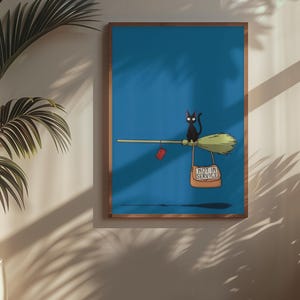 May include: A framed art print featuring a black cat riding a broom against a blue background. The broom has a red heart and a sign that reads "NOT IN SERVICE". The artwork is in a wooden frame.
