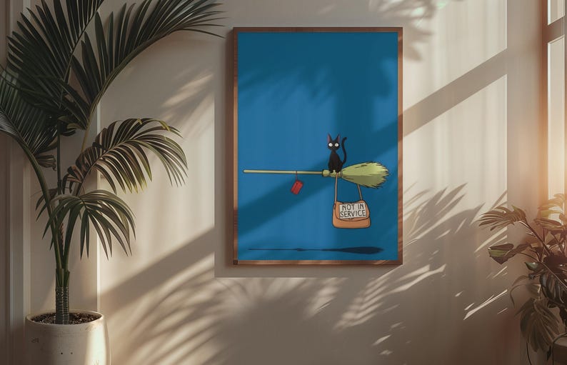 May include: A framed art print featuring a black cat riding a broom against a blue background. The broom has a red heart and a sign that reads "NOT IN SERVICE". The artwork is in a wooden frame.
