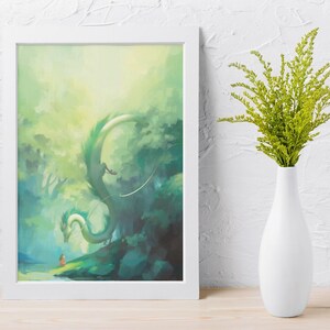 May include: A framed art print featuring a fantasy scene with a green dragon, a small figure, and a lush, green forest. The artwork is in a white frame, and a white vase with green foliage is next to it.