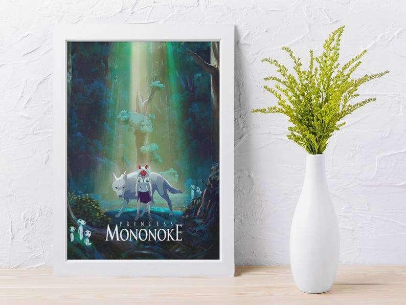 May include: A framed art print featuring a scene from "Princess Mononoke." The artwork depicts a white wolf, a figure in a purple dress, and forest elements. The title "Mononoke" is displayed at the bottom. A white vase with green foliage is on the right.