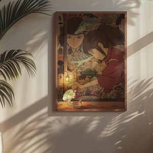 May include: A framed art print depicting a scene from an animated film. The artwork shows a young girl in a red garment, with a detailed background of a fantastical setting. The print is mounted on a wooden frame and displayed on a wall.