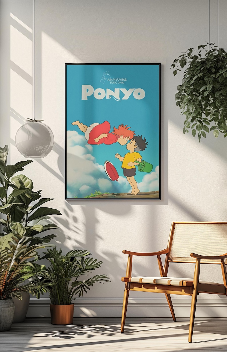 May include: Framed poster featuring the animated film "Ponyo." The poster has a blue background with the title "Ponyo" in white. The image depicts two animated characters kissing, with a red-clad figure floating above a boy in a yellow shirt.