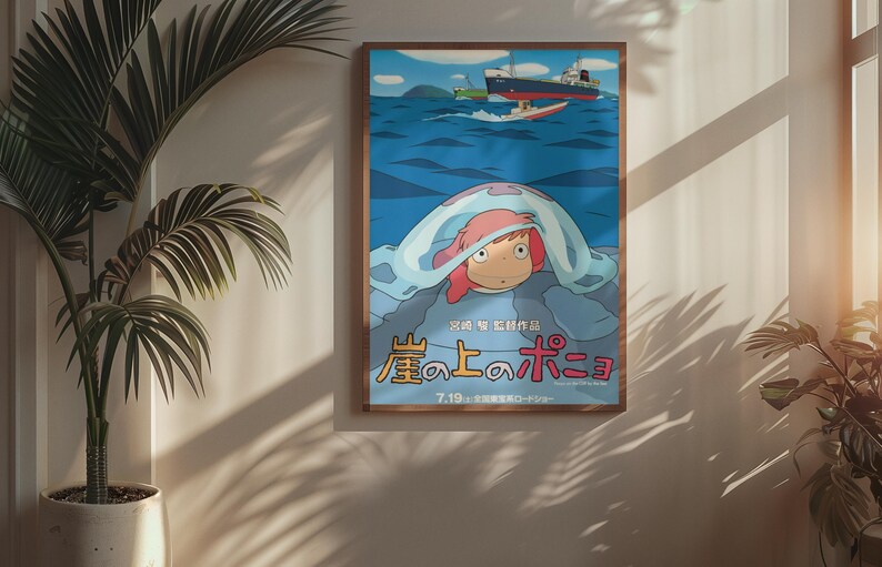 May include: A framed poster featuring a colorful illustration from the animated film "Ponyo." The artwork depicts a character with red hair under a blue blanket, with boats on the ocean in the background. The poster has Japanese text.
