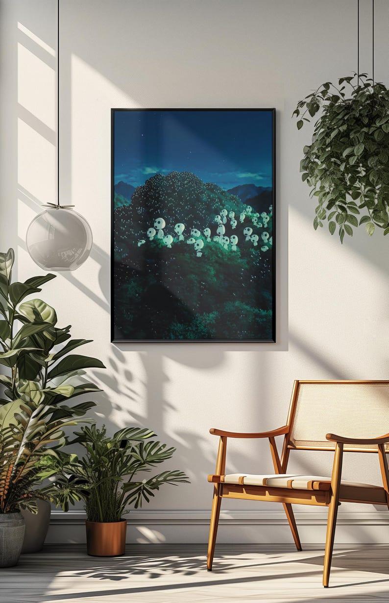 May include: Framed art print featuring a dark, forested landscape under a starry night sky. The artwork depicts a cluster of glowing white figures amidst the trees. The print is displayed on a white wall, with a wooden chair and plants in the foreground.