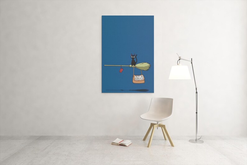 May include: A whimsical illustration on a blue background depicts a black cat riding a broom. The broom carries a bag with text and a red heart. The artwork is displayed on a wall, with a chair and lamp in the foreground.