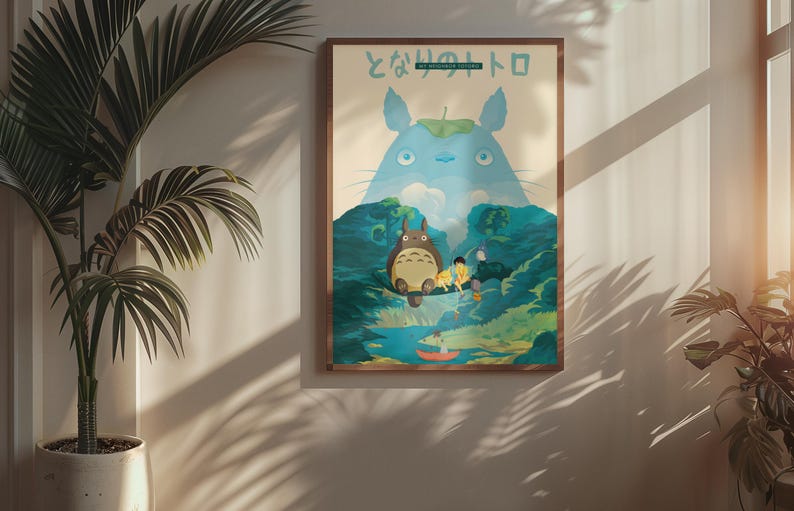 May include: A framed poster featuring a scene from the animated film "My Neighbor Totoro." The artwork depicts Totoro, a large forest spirit, with other characters in a lush, green landscape. The poster is in a wooden frame and is displayed on a wall.