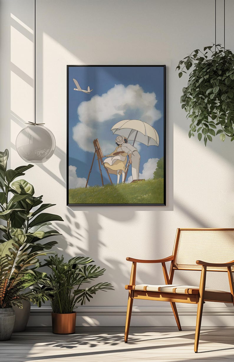 May include: Framed art print depicting a couple painting outdoors under a parasol. The artwork features a blue sky with clouds and a flying bird. The scene is set on a grassy hill, with a wooden easel and a light color palette.