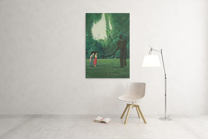 May include: A rectangular wall art print featuring an animated scene of two figures standing in a lush green forest clearing facing a tall, slender, dark brown robotic figure with a long arm extended toward them under a bright white sky.