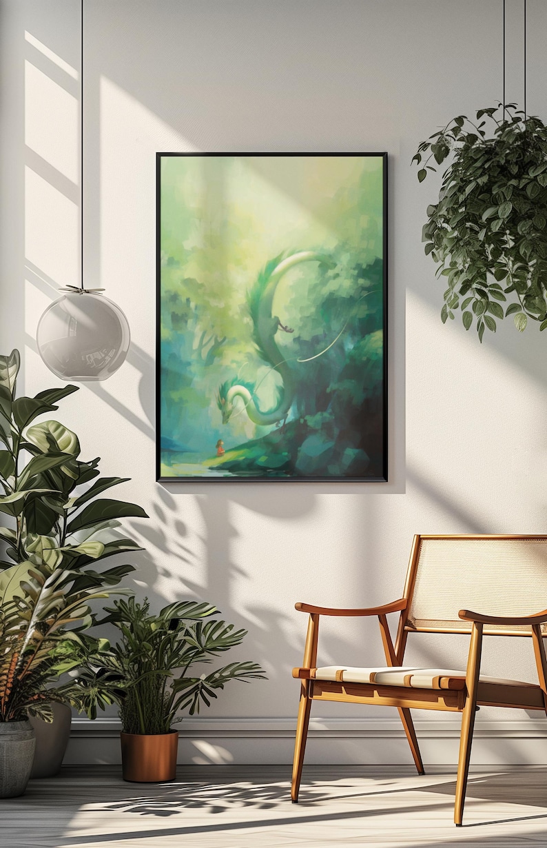 May include: A framed art print featuring a fantasy scene with a green dragon in a forest setting. The artwork has a painterly style with shades of green and blue. A small figure is in the foreground. The print is displayed on a white wall.