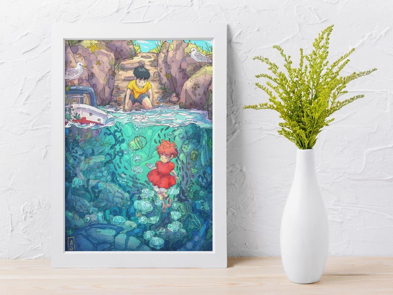 May include: A framed art print featuring a split scene of a boy on a rocky shore and a girl underwater with fish. The artwork has a vibrant color palette with blues, greens, and reds. A white vase with green stems is on the right.