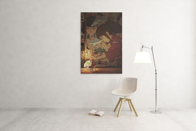 May include: A framed print depicting an anime scene with two women in traditional attire. One is holding a glowing object. The artwork has warm tones and is displayed on a white wall.