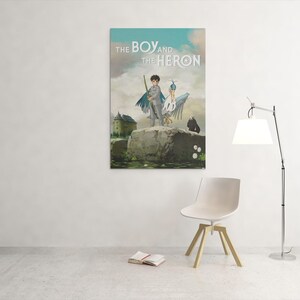 May include: A framed poster titled "THE BOY and the HERON" depicts a boy with a heron on a rock. The artwork features a castle, a dark figure, and a cloudy sky. A white chair, a floor lamp, and a book are in the room.