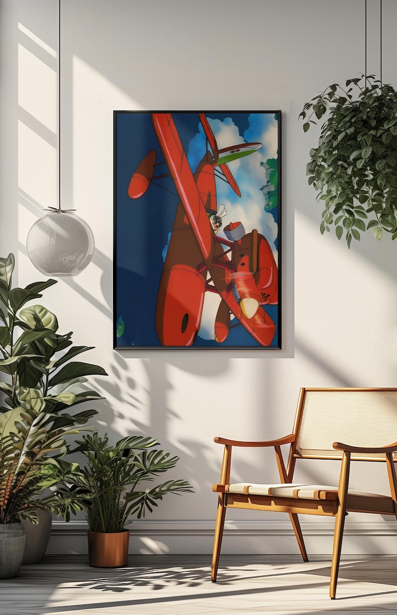 May include: Framed art print featuring a vibrant illustration of a red biplane soaring through a blue sky with clouds. The artwork depicts a pilot in the cockpit. The print is displayed in a black frame, suitable for wall decor.