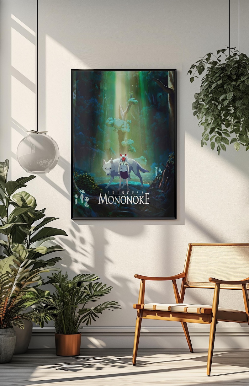 May include: A framed poster featuring the anime film "Princess Mononoke." The artwork depicts a young girl with a wolf, set in a lush forest with the film's title at the bottom. The poster is displayed on a white wall.