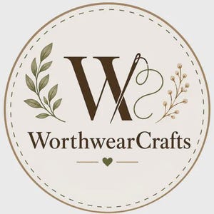May include: A circular logo featuring a large dark brown letter W integrated with a needle and thread. The text WorthwearCrafts appears below in dark brown, flanked by green leaf illustrations. A small heart sits centered at the bottom edge.