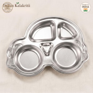 May include: A silver-colored stainless steel divided tray shaped like a car. The tray features two large circular sections at the bottom, two smaller upper sections, and a central triangular compartment, all with a smooth, polished metallic finish.