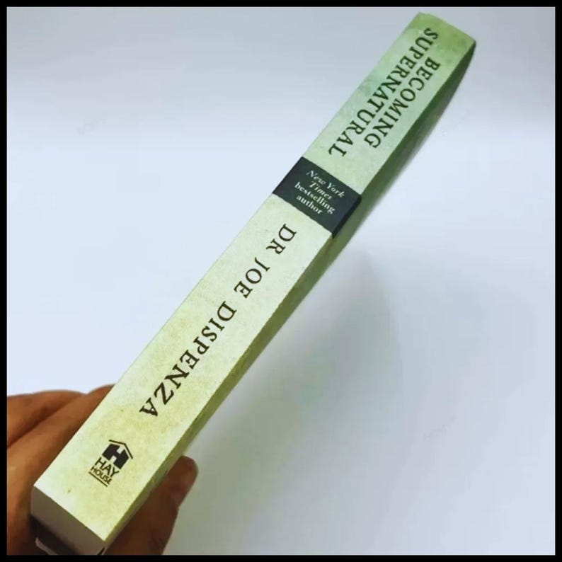 May include: A book titled "Becoming Supernatural" by Dr. Joe Dispenza. The book has a light green cover with black text and a black band that reads "New York Times bestselling author". The Hay House logo is visible.