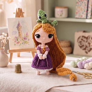 May include: A crocheted doll with long golden yarn hair, wearing a purple dress with white sleeves and a white hem. A small green crocheted lizard sits atop the doll's head. The doll has large black eyes and a light pink complexion.